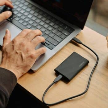 A man sitting at a table using a laptop computer